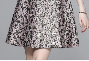 Close-up of beaded waist detail and floral lace trim on pink floral satin dress