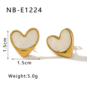 Macro detail of 1.5cm gold heart earrings with white mother of pearl inlay