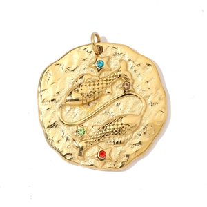 Macro detail of 18K gold plated Pisces zodiac pendant with colorful rhinestones