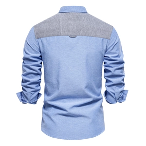 Detail of blue Oxford shirt featuring gray contrast color stitching on the back yoke