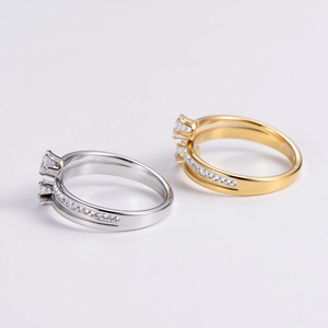 Macro view showing the spiral design and zircon inlay details of the gold and silver rings