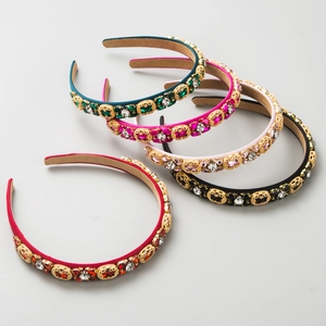 Detailed macro view of five baroque headbands with inlaid rhinestones and gold metal filigree