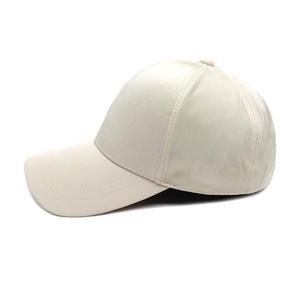 Detail of off-white six-panel baseball cap with reinforced stitching and curved brim