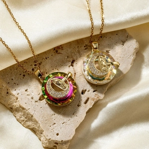 Elegant gold pendant necklace with colorful crystal moon and religious relief on stone