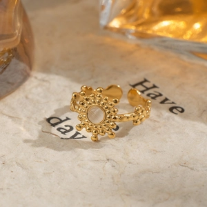 Vintage gold open ring with sunburst natural stone on textured artisan paper background