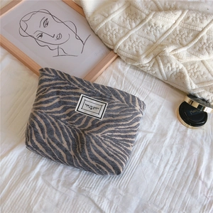 Detailed texture of zebra pattern woven fabric pouch with Time to Party patch