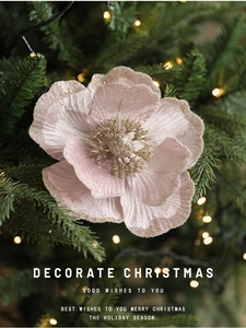 Close-up of pink velvet Magnolia flower with glitter on Christmas tree branches