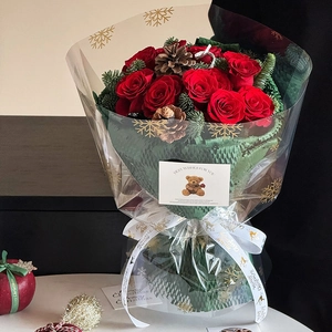 Christmas bouquet with red roses and snowflake cellophane wrap for holiday gift wrapping
