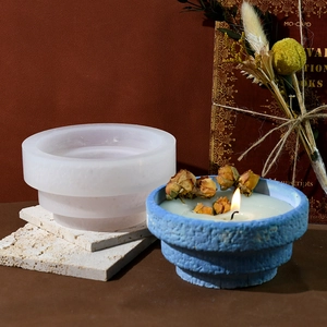 Detail of 3-tier round step silicone mold and finished blue textured candle cup