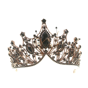 Vintage bronze bridal crown with black crystals and large center gemstone on white background