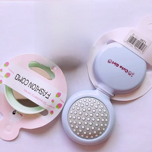Portable folding hair brush with mirror in pastel green and blue strawberry theme