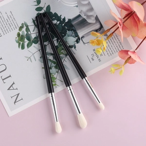 Set of 3 synthetic wool eyeshadow brushes with black wooden handles on a floral background