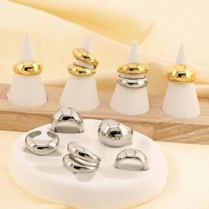 Polished 18k gold plated minimalist dome rings set on elegant product display stands