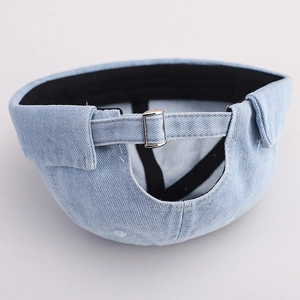 Detail view of the washed light blue denim brimless cap featuring a silver metal back buckle