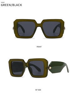 Close-up of olive green square sunglasses with golden snake head hardware on the temple