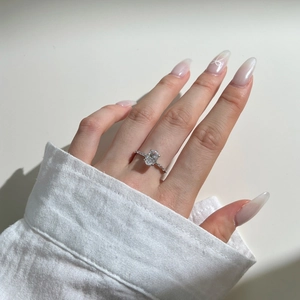 Macro detail of an S925 sterling silver ring with oval centerpiece on a model hand