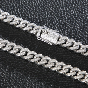Close-up of hip hop silver Cuban link chain with micro-paved rhinestones on black leather