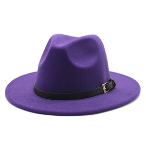 Detail of purple fedora hat with black leather band and golden metal buckle close-up