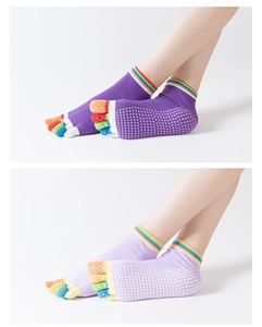 Detail of non-slip yoga socks with rainbow toes and silicone grips on the sole