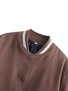 Detail of the brown baseball jacket collar with white stripes and blue satin lining