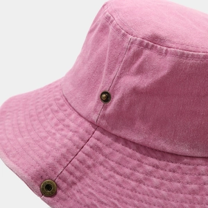 Detail of pink washed cotton fabric with metal eyelets and stitching on hiking hat