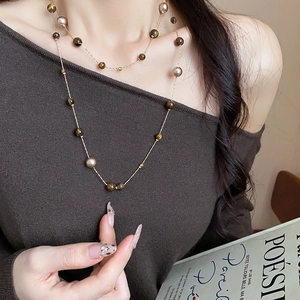 Tiger eye and pearl beaded long necklace with gold chain on brown knit top