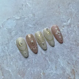 Detail of 5D embossed nail stickers featuring gold celestial sun and moon motifs