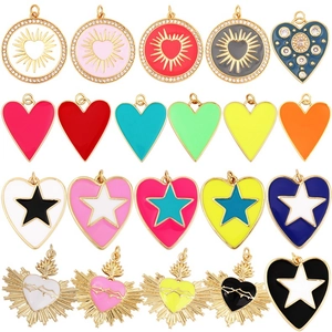 Macro shot of 20 colorful enamel heart and sun charms in gold for DIY jewelry making