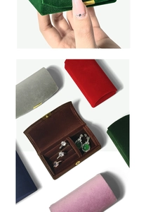 Close-up of velvet jewelry boxes in multiple colors with ring slots and stud holes