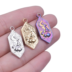 Three hexagonal rabbit and moon pendants in gold, silver, and iridescent steel finishes