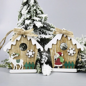 Wooden Christmas hanging ornaments featuring Santa, reindeer and snowman on a tree branch