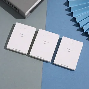 White cardboard jewelry display cards for earrings and necklaces with Thank You text