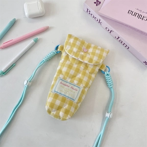 Quilted yellow checkered camera bag with adjustable blue strap and lifestyle accessories