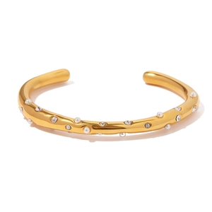 Bracelet jonc ouvert en acier doré 18 carats orné de perles blanches et zircons