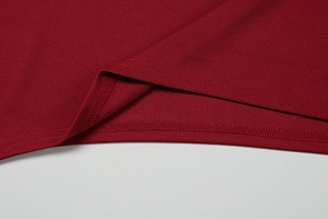 Detail view of burgundy knitted dress featuring high-quality double stitching and texture