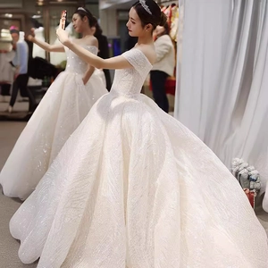 Sparkling off-the-shoulder star bridal ball gown with a heavy train and luxury texture