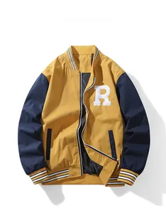 Detail of embroidered R patch and contrast ribbed collar on yellow baseball jacket