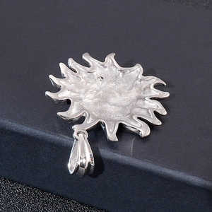 Macro shot of silver sun pendant back showing engraved S925 hallmark on the bail