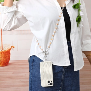 Crossbody beaded phone strap with amber heart beads and wavy white phone case