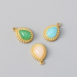 Three teardrop bohemian pendants in green, blue, and pink with gold beaded edges