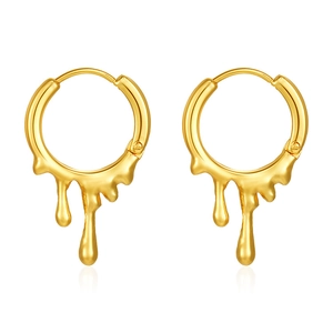 Macro detail of golden lava drop liquid metal texture on stainless steel earrings