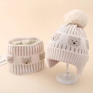 Detailed knit texture and soft plush lining of the toddler bear hat and scarf set