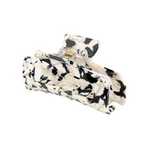 Macro shot of 8.2cm rectangular acetate hair claw with marble pattern and gold spring