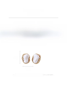 Detail view of vintage oval gold earrings with white acrylic inlay and side rhinestones