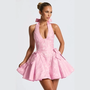Close-up of pink jacquard fabric texture and waist bow detail on halter V-neck mini dress