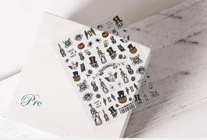 Macro shot of Halloween TS-186 nail stickers featuring sketch pumpkin and skull motifs