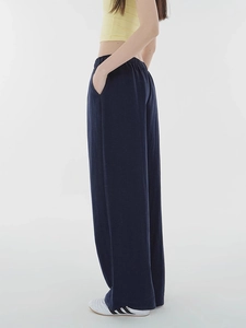 Detail showing elastic high waist design and breathable fabric texture of wide leg trousers
