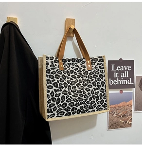 Detail showing leopard print texture and natural jute stitching on the tote bag