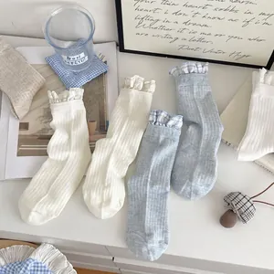 Chic women's crew socks with ruffled cuffs and blue plaid lace trim in vintage style