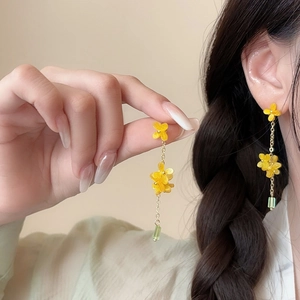 Close-up of sweet osmanthus pearl tassel earrings with yellow flowers and green beads